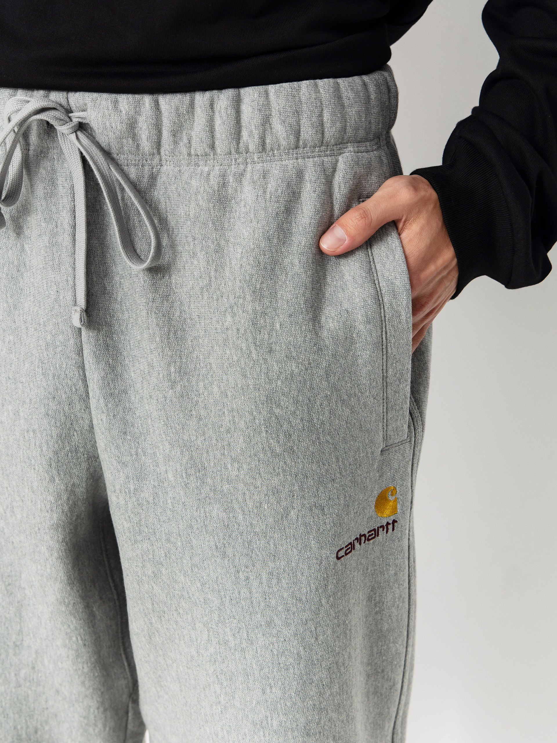 Nohavice Carhartt WIP American Script Jogging (grey heather)