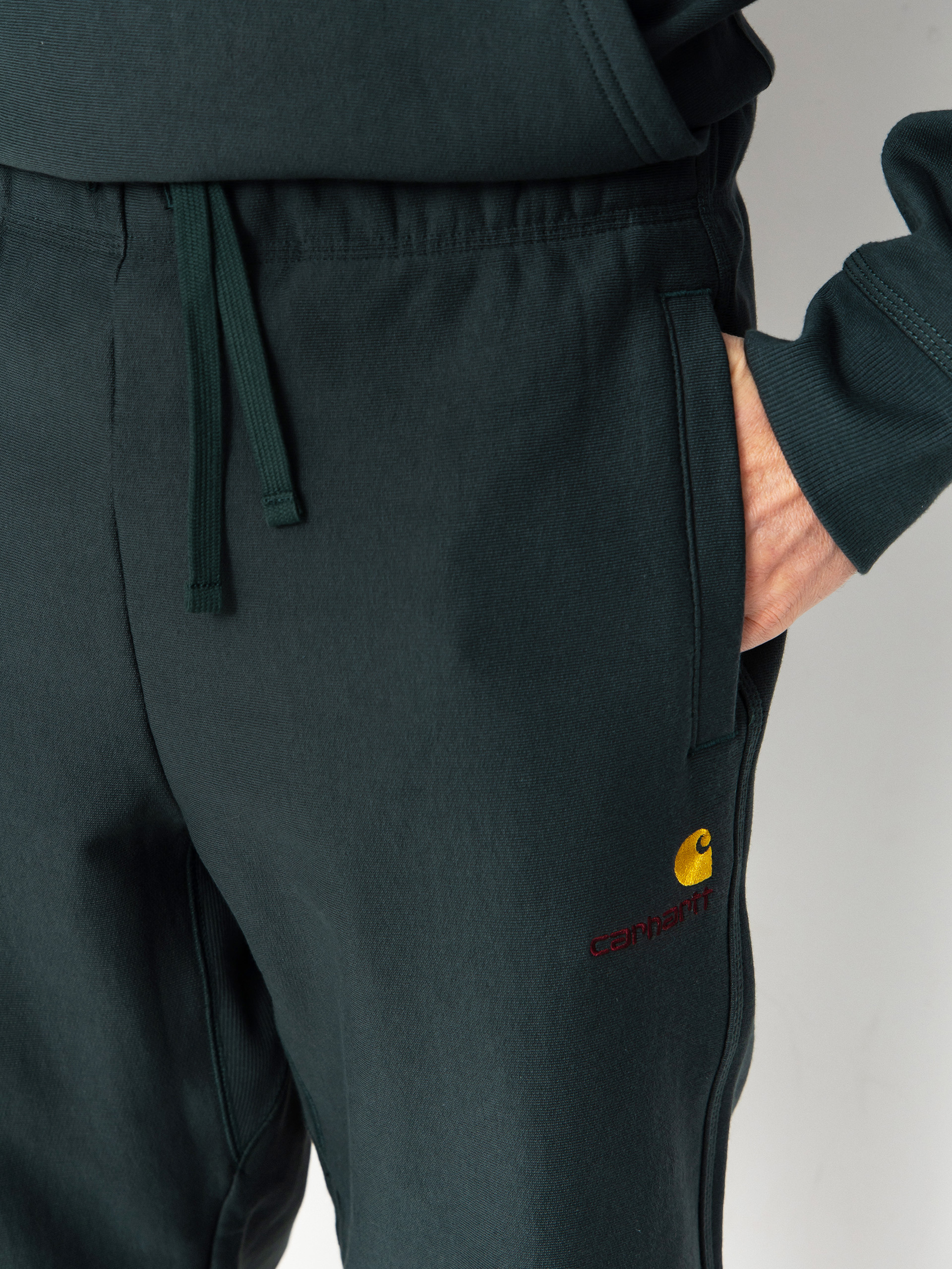 Nohavice Carhartt WIP American Script Jogging (kale green)