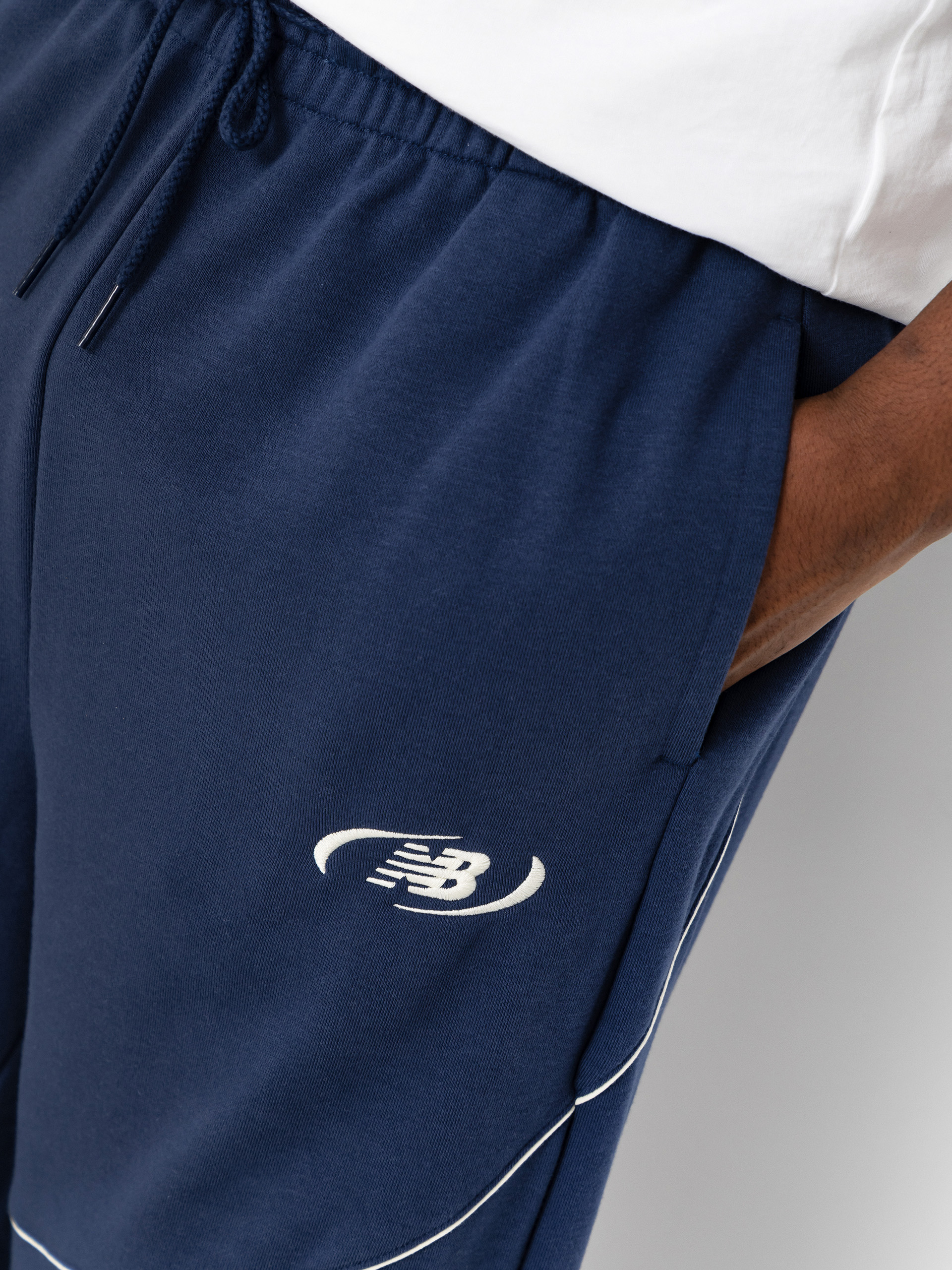 Nohavice New Balance Trackside French Terry (navy)